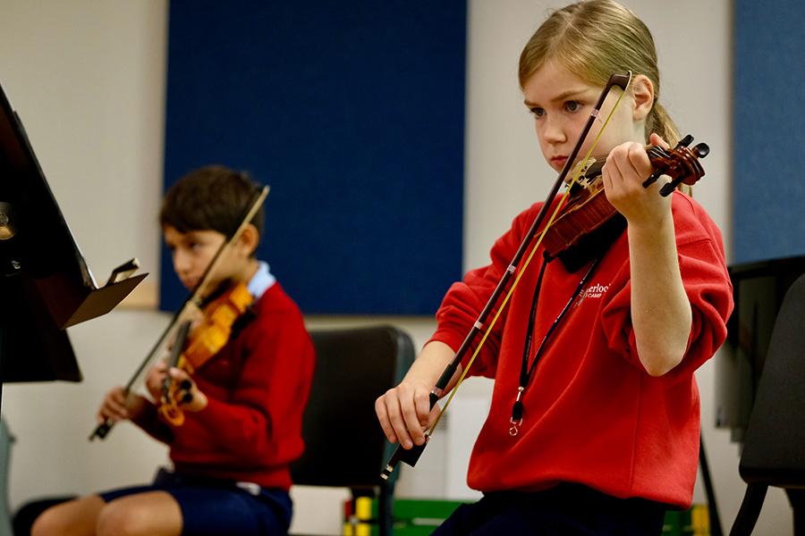 Junior violinists rehearse in the Music Center.