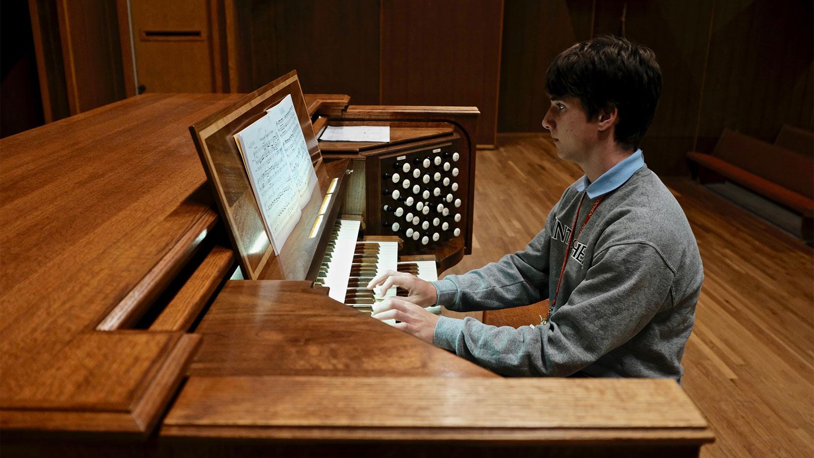 A boy plays the organ
