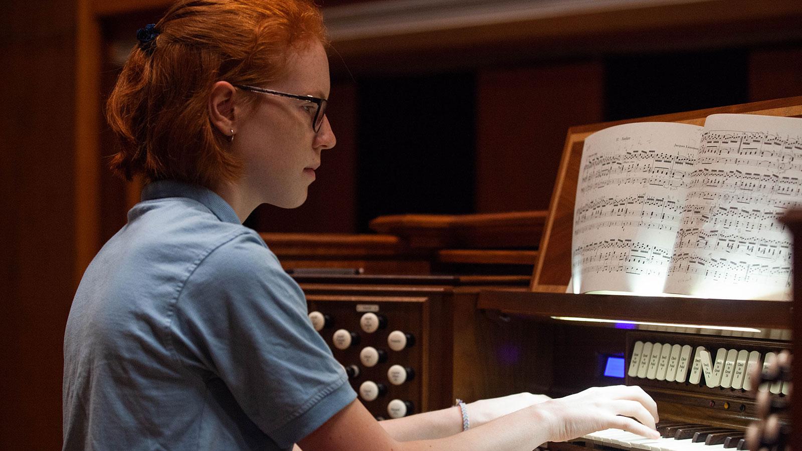 A red-haired girl at an organ