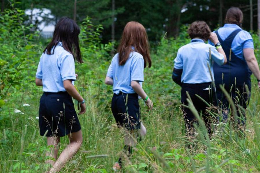 Students walk through a field